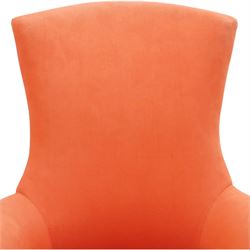 Victorian coral red upholstered armchair, the swept high back above padded arms with rolled fronts, on short turned ebonised front supports with castors