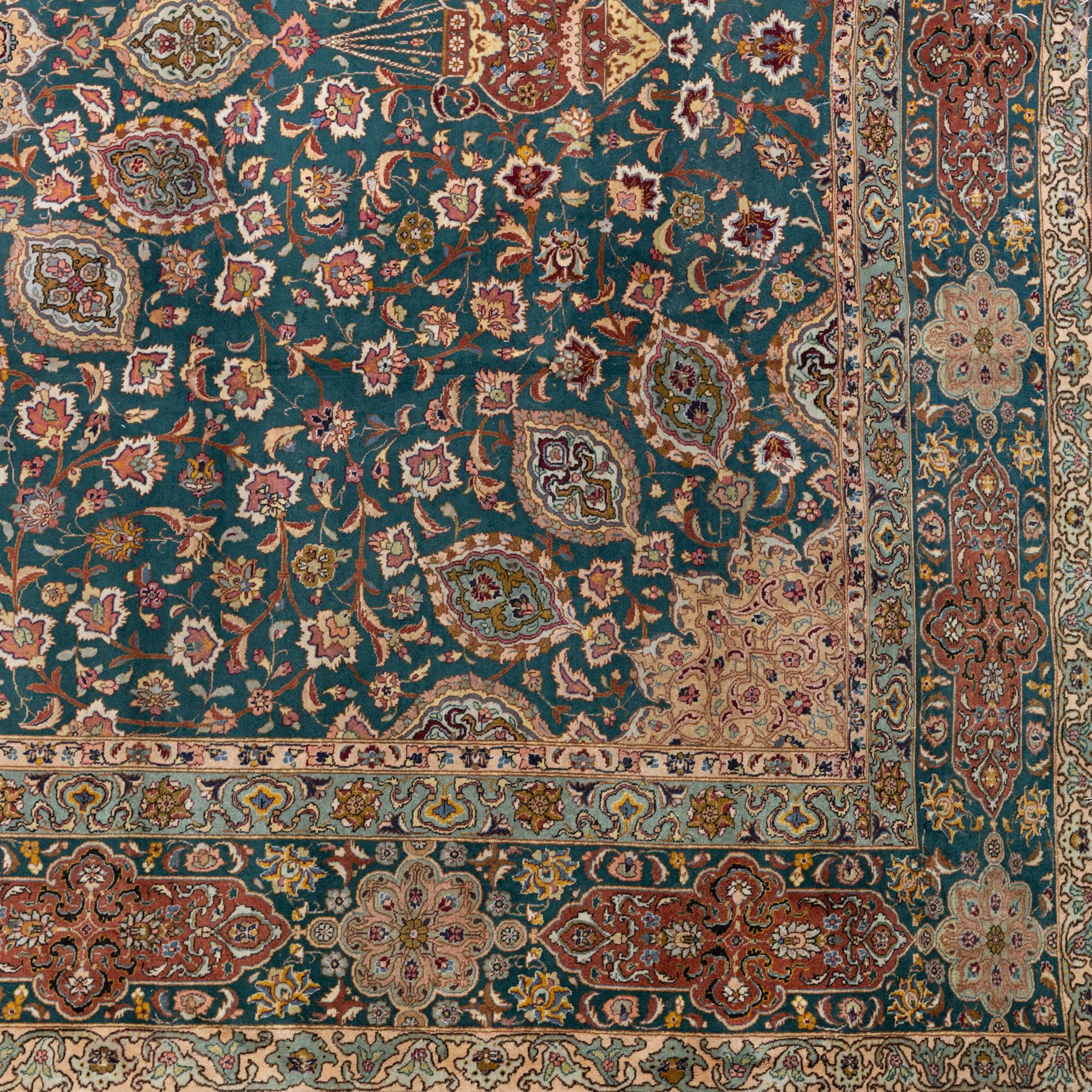 Persian Tabriz type carpet, the teal ground decorated with central medallion, radiating palmettes and dense floral scrollwork, within multiple floral borders