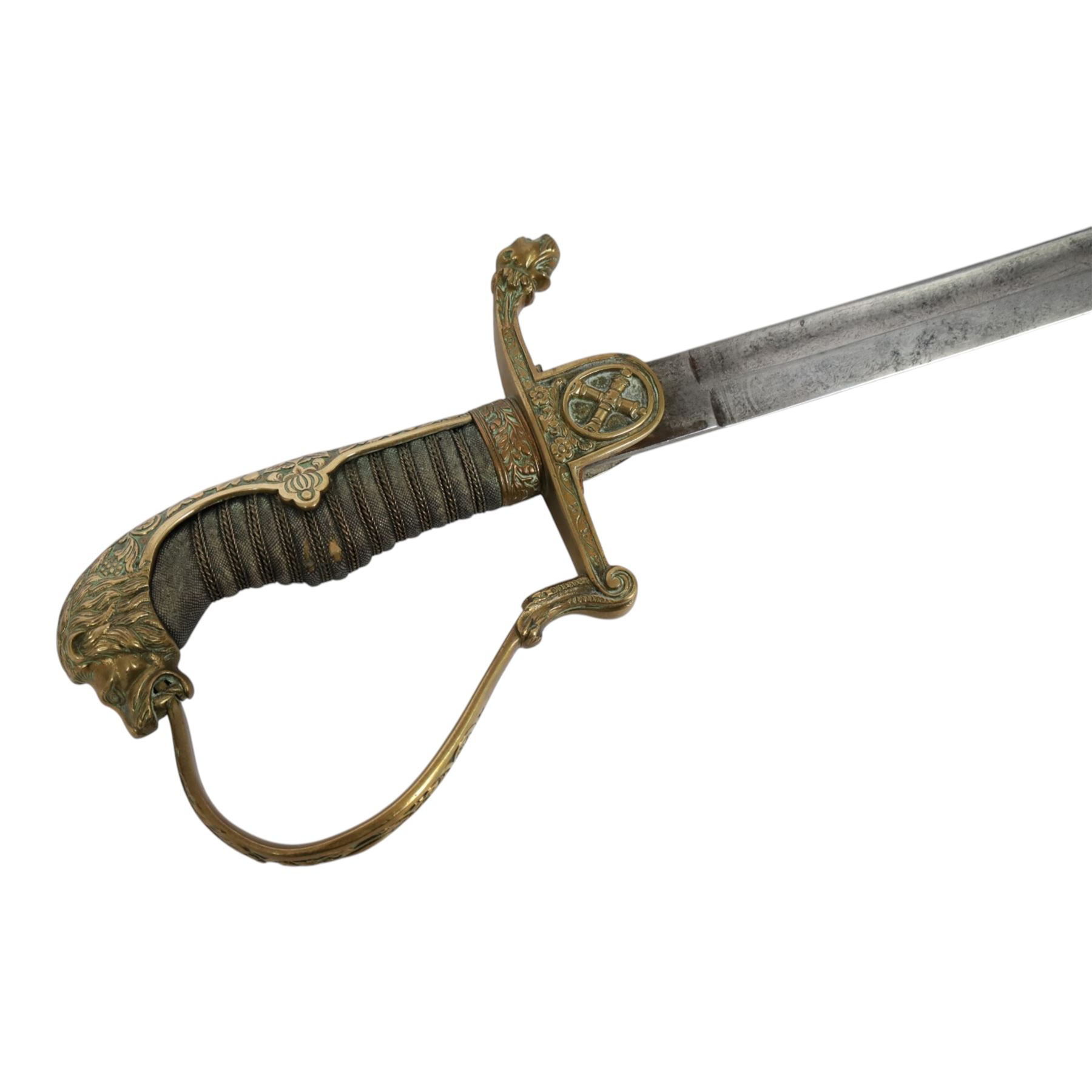 WWI Prussian Artillery Officer's dress sword, with 83cm single edge fullered steel blade, brass stirrup hilt, the langet with crossed cannon barrels and a vacant shield cartouche, the curved knuckle bow cast with acorns and oak leaves, wire bound grip and lion head pommel, with steel scabbard, overall L100cm