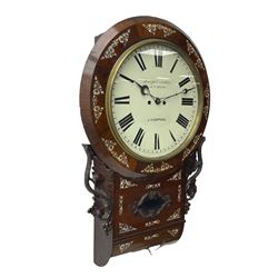 Joseph Critchley of Liverpool -  early 19th century twin fusee 8-day rosewood and mother of pearl inlaid drop-dial wall clock c1820, inlaid circular wooden dial surround with carved ears representing grapes and vine leaves, glazed box with a scroll carved surround, curved base and pendulum adjustment door, 14” painted dial with Roman numerals, minute track, and pierced steel hands within a cast brass bezel and flat glass, dial pinned to a four pillar chain driven fusee movement striking the hours on a bell. With pendulum and key.