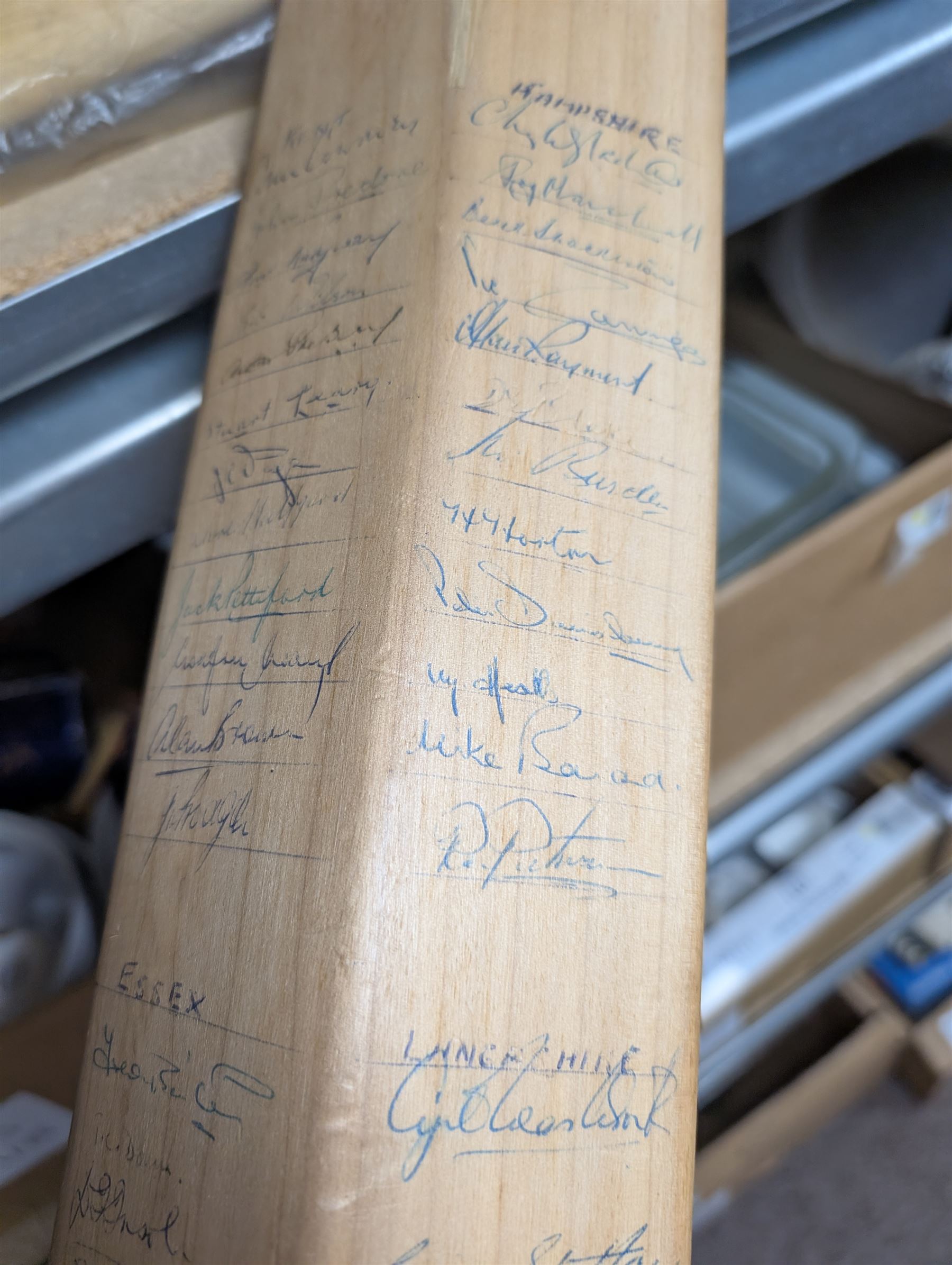 Two signed cricket bats, with signatures including Colin Cowdrey