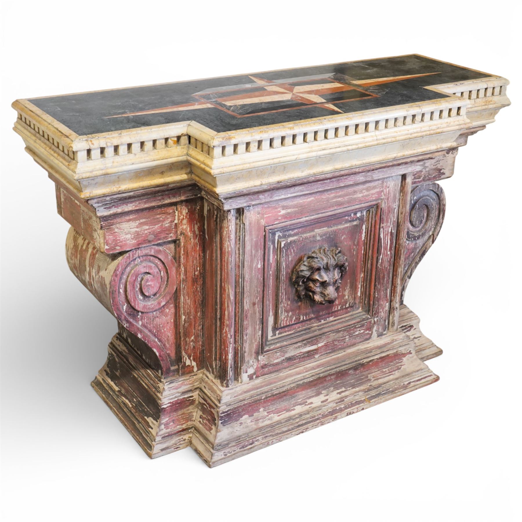 A 20th century Italian Neoclassical console table of monumental architectural form, inspired by Roman altar and sarcophagus prototypes; the rectangular marble top with dentil-moulded edge and polychrome geometric compass-star inlay, executed in contrasting marbles on a dark green ground, above a pedestal base of simulated stone finished in red porphyry-type tones, centred by a lion’s mask in relief and flanked by Ionic scroll volutes, raised on a stepped plinth base