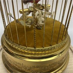 Swiss Reuge Music bird cage automaton music box, the bird with articulated head and beak, in a gilt brass cage, with a glass dome and stand, H30cm