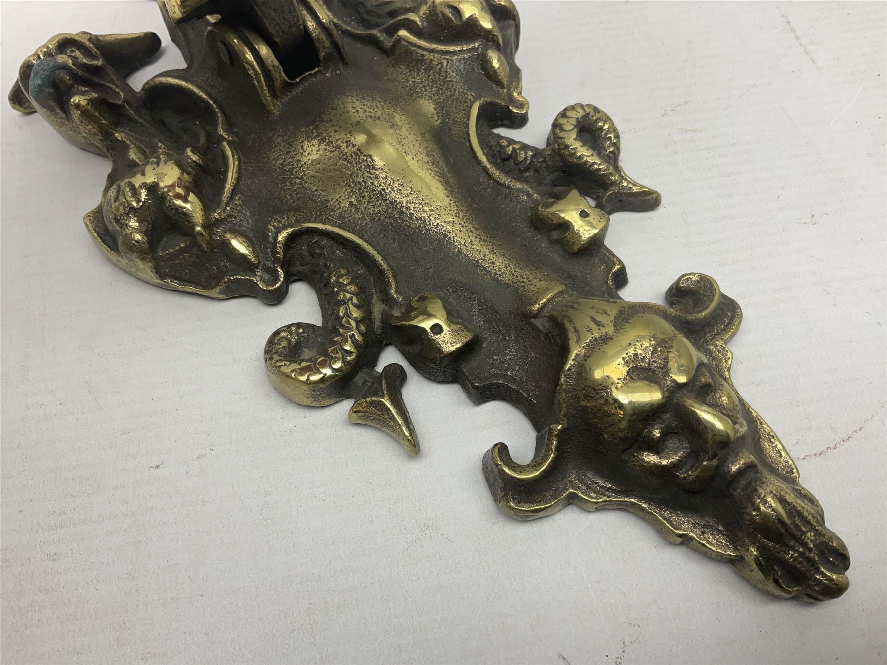 Gothic style cast brass door knocker, modelled with the Greek three-headed hell hound Cerberus on Rococo style base with central knocker of tear drop above Hades, God of the underworld, L29cm