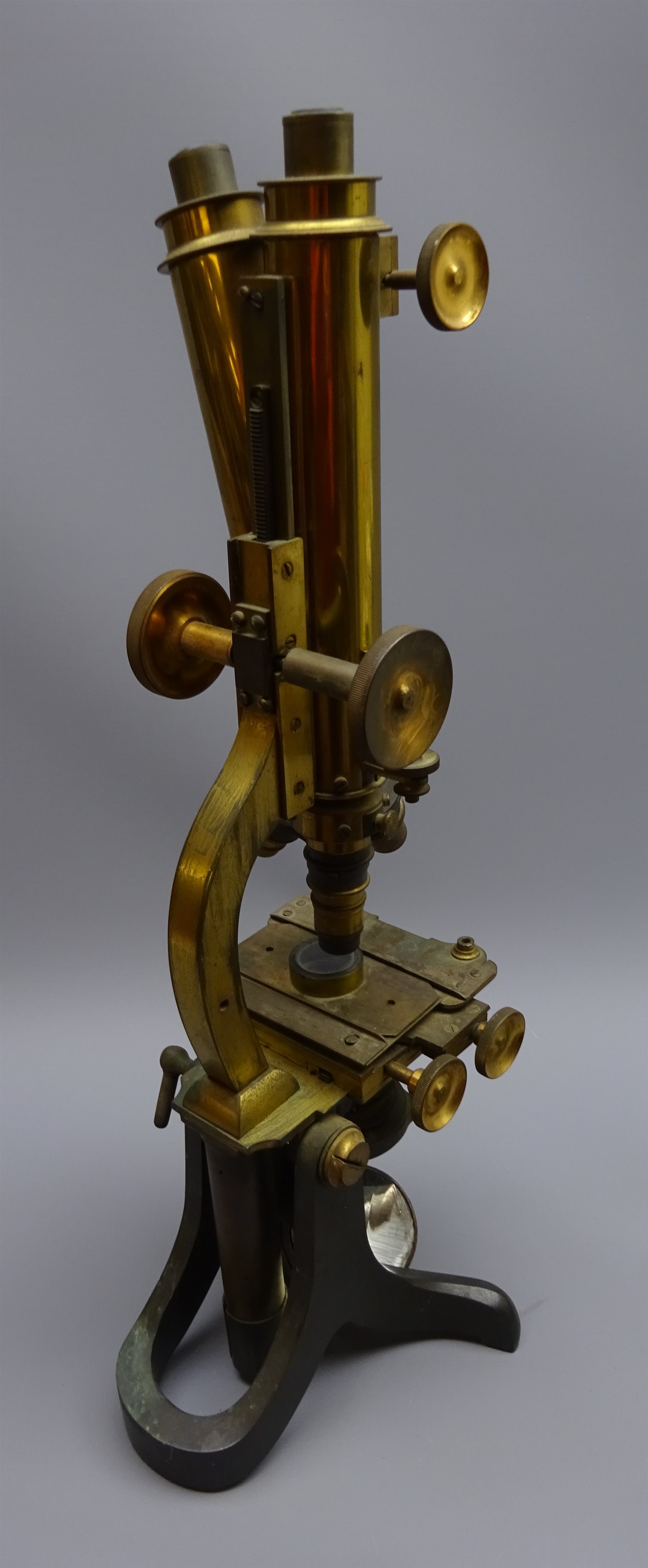 Late 19th century brass binocular microscope, with rack and pinion coarse and fine adjust E
