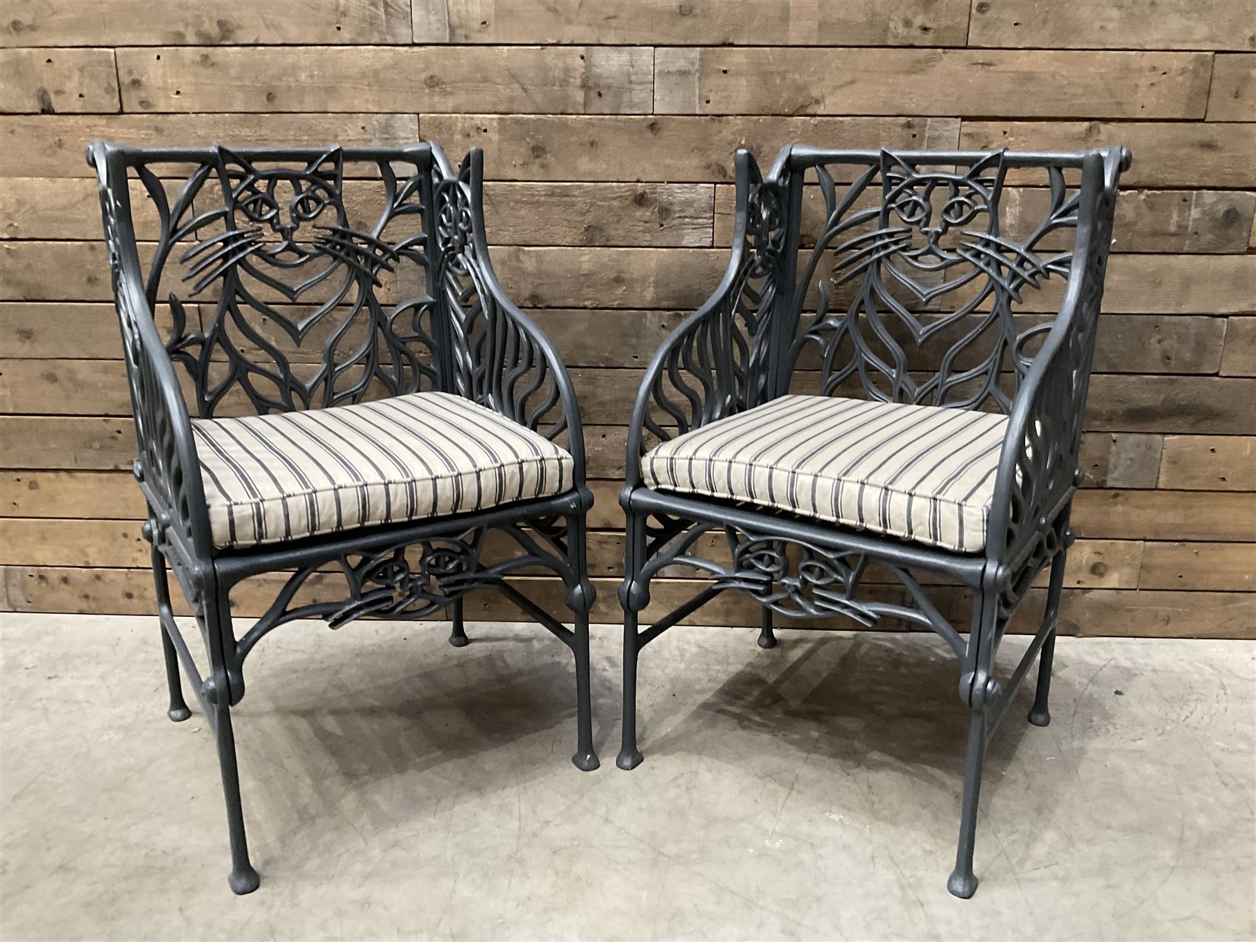 Richard Bawden (1936-2024): Pair of Cat design painted cast iron garden armchairs