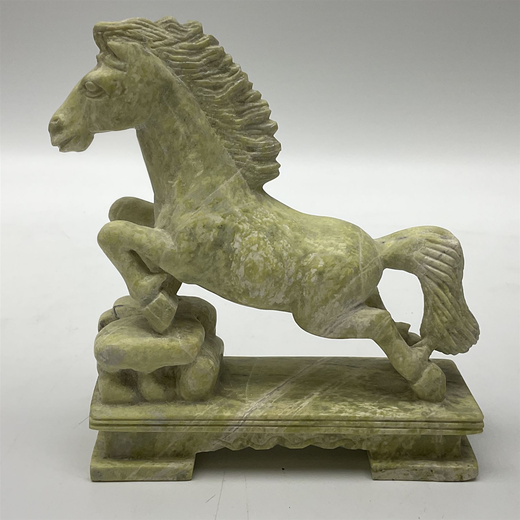 Cornish carved serpentine model of a lighthouse, together with a Chinese soapstone figure of a horse, another carved horse figure and a carved hardstone armadillo