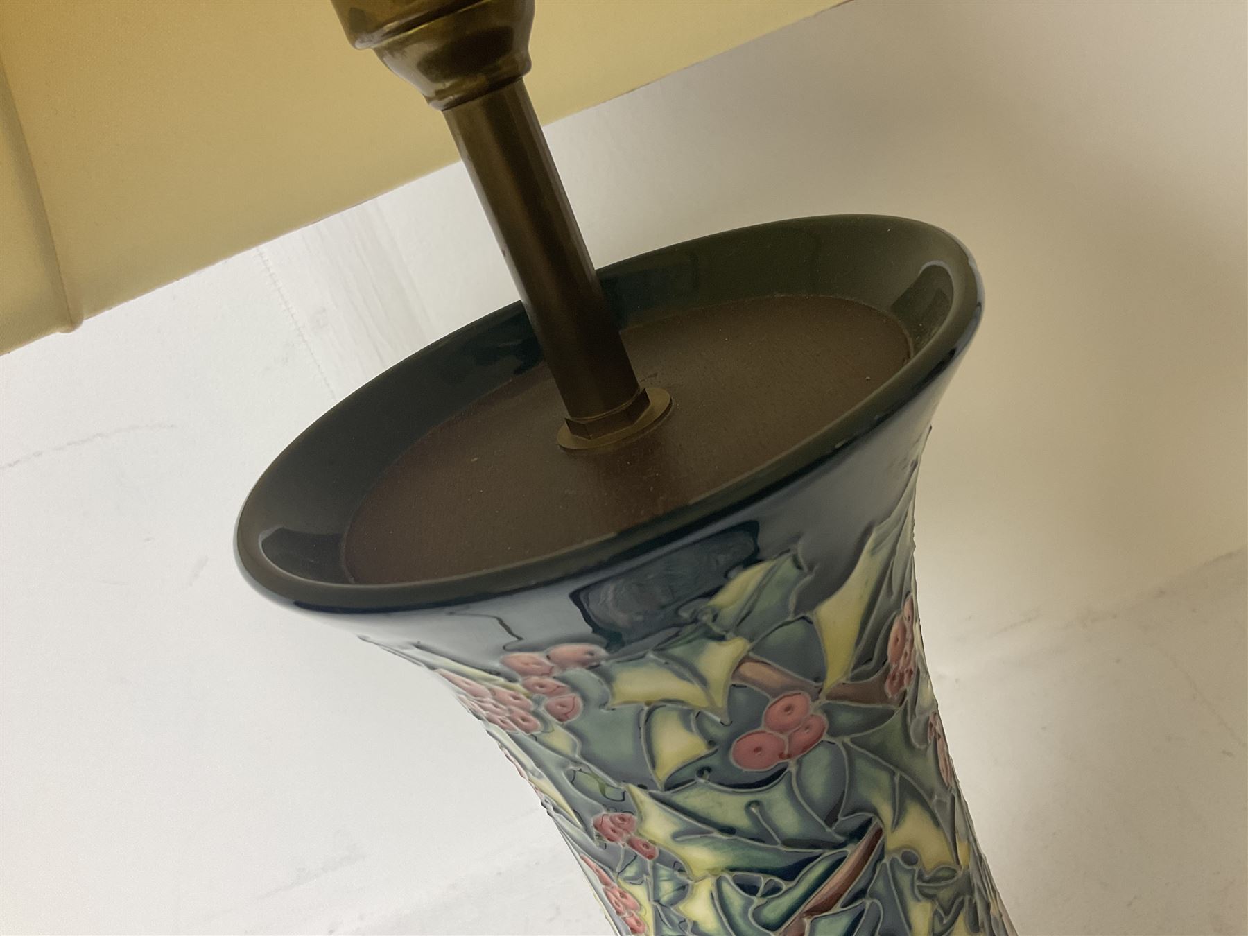 Moorcroft table lamp, of waisted form, decorated in the Holly Hatch pattern, on wooden plinth, with accompanying cream shade of lobed form, with piped detail, H33cm (excluding fitting)