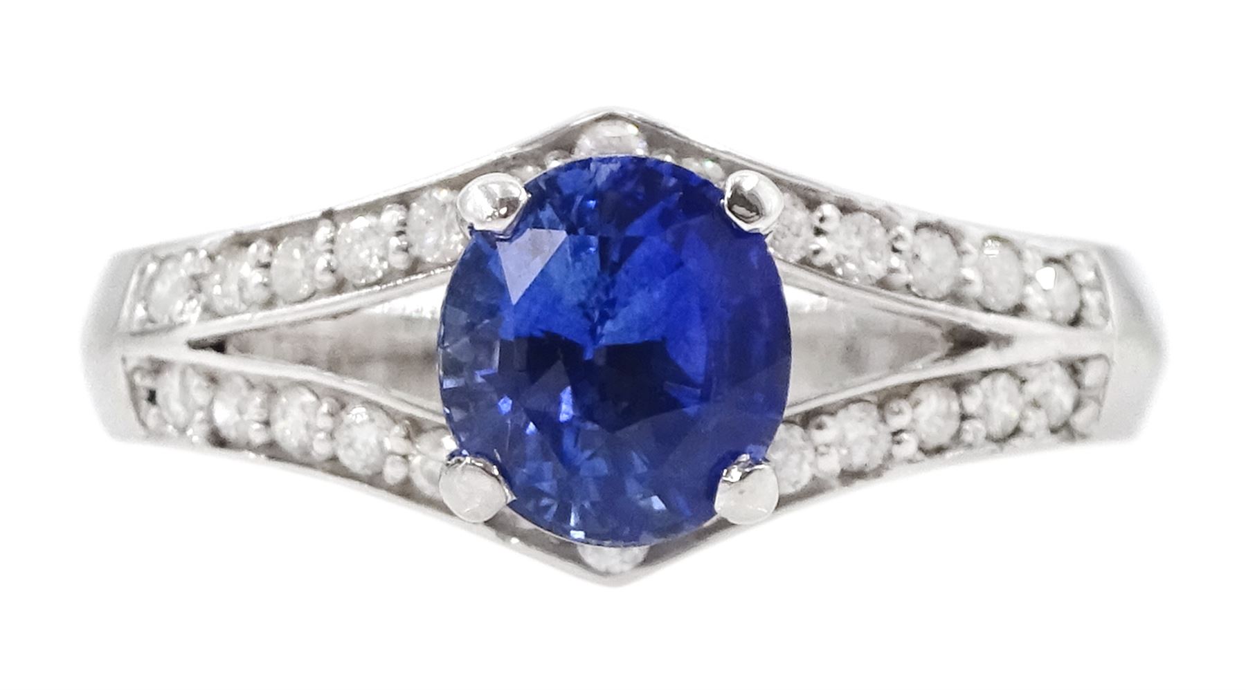 White gold sapphire and diamond ring, single oval cut sapphire of approx 1.00 carat, with split design diamond set shoulders, hallmarked 14ct