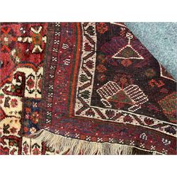 Shiraz red ground rug, central medallion, repeating border