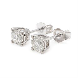 Pair of platinum diamond earrings, each stud set with a single round brilliant cut diamond, stamped PT 950total diamond weight approx 1.05 carat