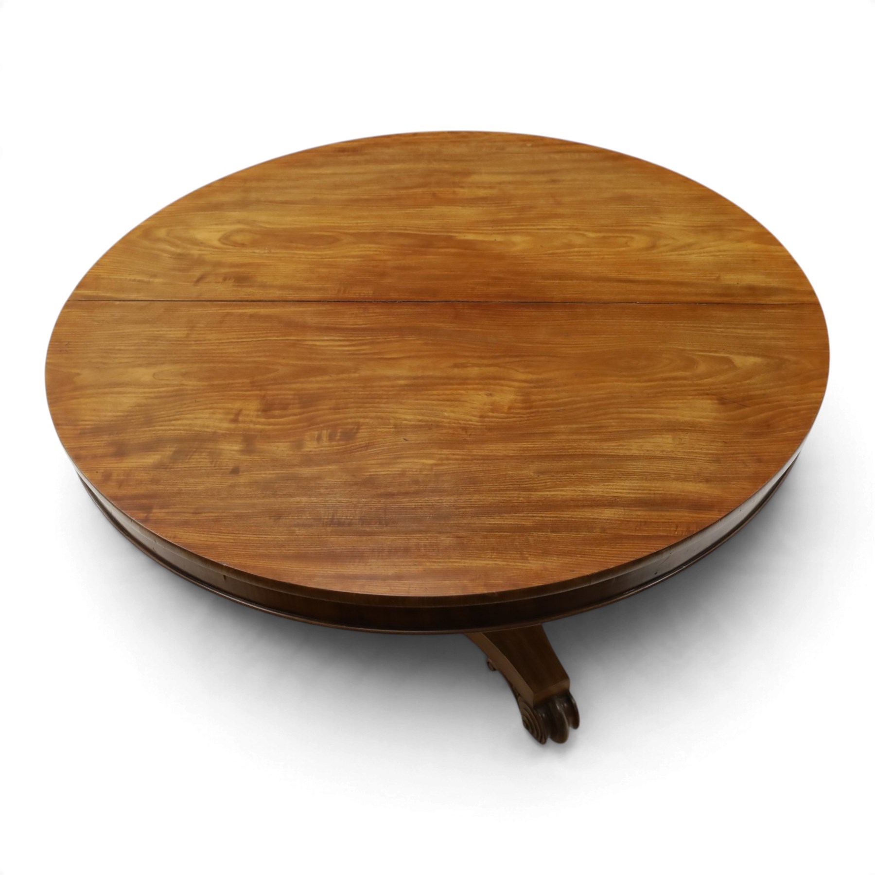 William IV mahogany circular breakfast table, banded frieze over a turned decagon pedestal with lappet carved collar, terminating to a triform platform base with scroll feet and castors
