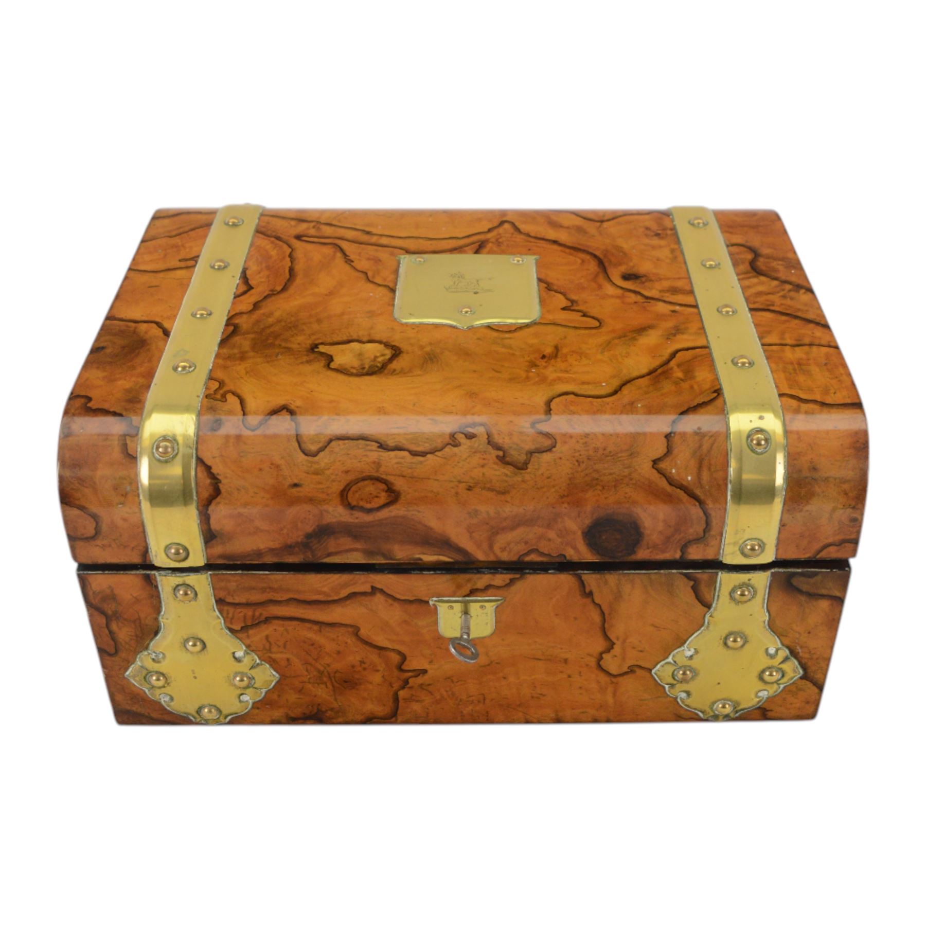 19th century walnut and brass bound games compendium box, painted to enhance the grain, of rectangular form, the hinged opening cover with rounded sides, central brass cartouche with engraved lion crest, and brass riveted straps, opening to reveal a red leather and blue silk lined compartmented interior, with fold-down games board, and lift-out tray containing playing cards, ebony turned dice towers, white and red stained bone draughts, and chess pieces, ivory dice, and ivory and ebony whist markers, and brass bezique board, cribbage board and markers, H15cm W32cm D24cm
This lot has been registered for sale under Section 10 of the APHA Ivory Act