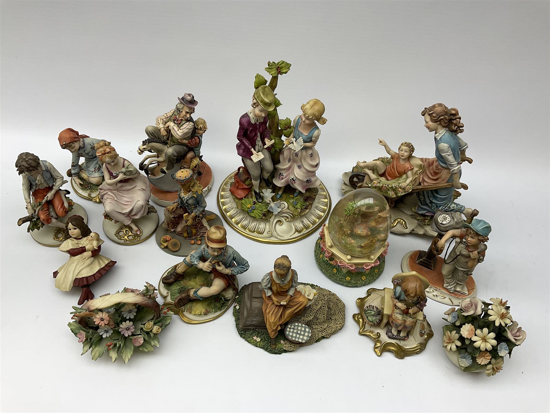 Collection of Capodimonte and Naples figures, including boy with telephone, boy and girl by a tree, man on rocking horse etc.  