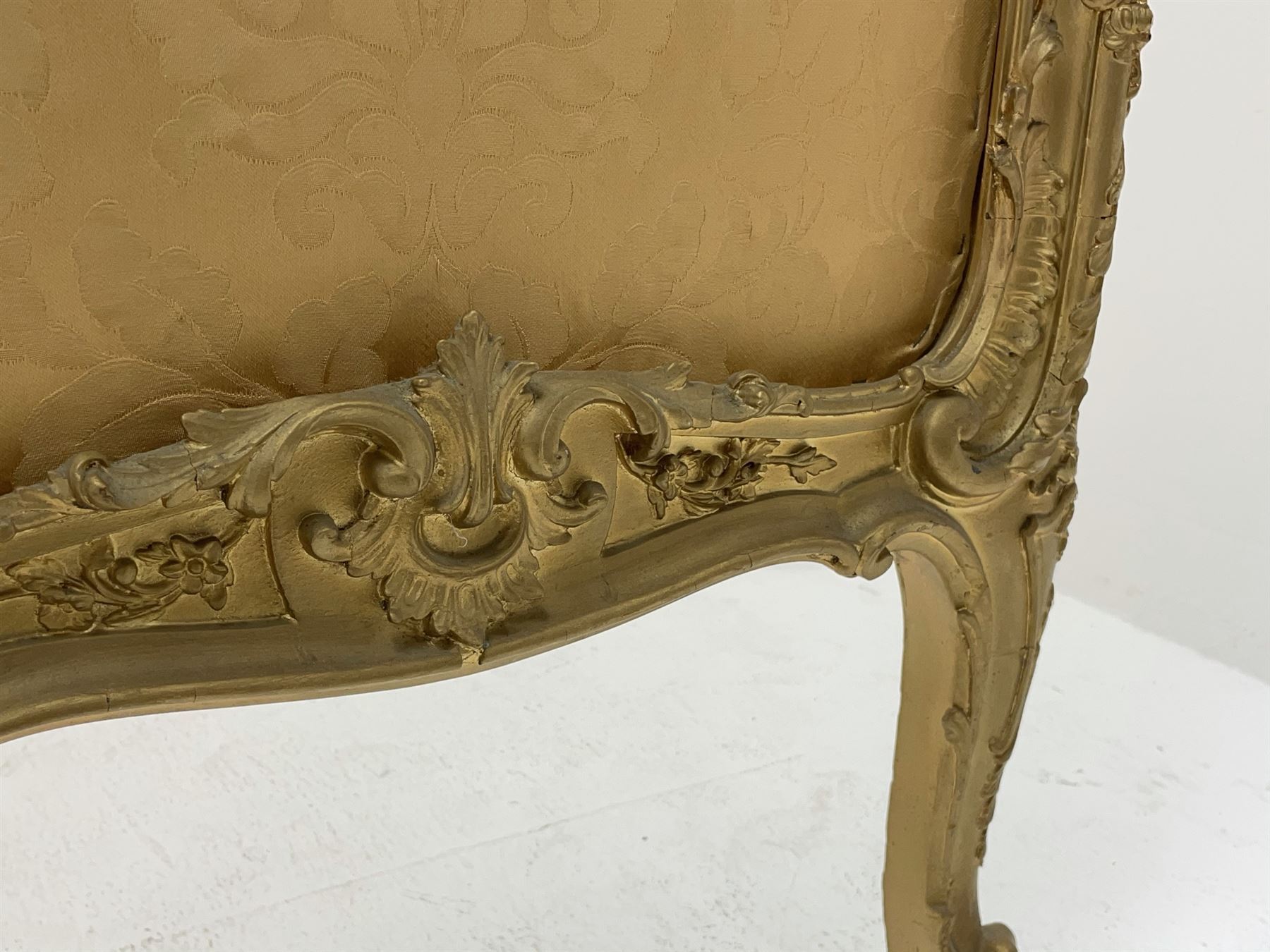 Late 19th/early 20th century French Rococo style gilt wood and gesso dressing screen, four double hinged panels, each with shaped cresting rail over shell and floral frieze, moulded frame with flower head and scroll decoration, acanthus leaf cabriole supports with castors, upholstered in gold Damask fabric
