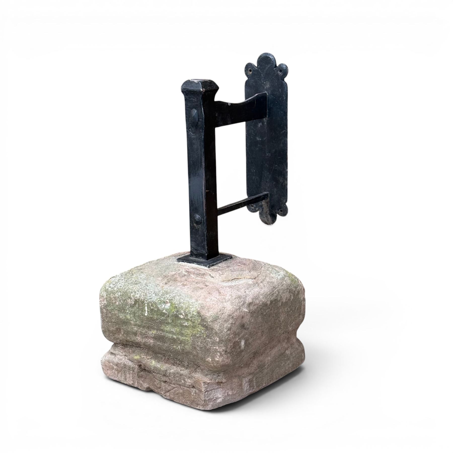 Large wrought metal boot scraper in black painted finish, set in formed stone plinth