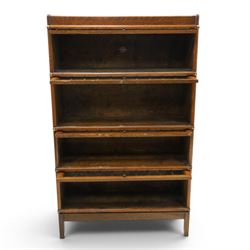 Globe Wernicke - oak four tier barrister bookcase, with leaded glazed fronts, raised on square supports