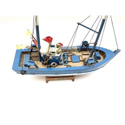 Wooden model of RMS Titanic, on a fixed black stand bearing plaque inscribed 'Titanic 1912', L54cm, H22cm, together with model of a sloop, gaff rigged on stand bearing plaque inscribed 'Sloop' L32cm, H42cm; and model of a fishing trawler on a stand bearing plaque inscribed 'Chalutier' L35cm, H28cm (3)