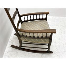 William Birch for Liberty & Co. - Arts and Crafts period oak ladder back rocking chair, the arms supported by a series of turned spindles, upholstered seat