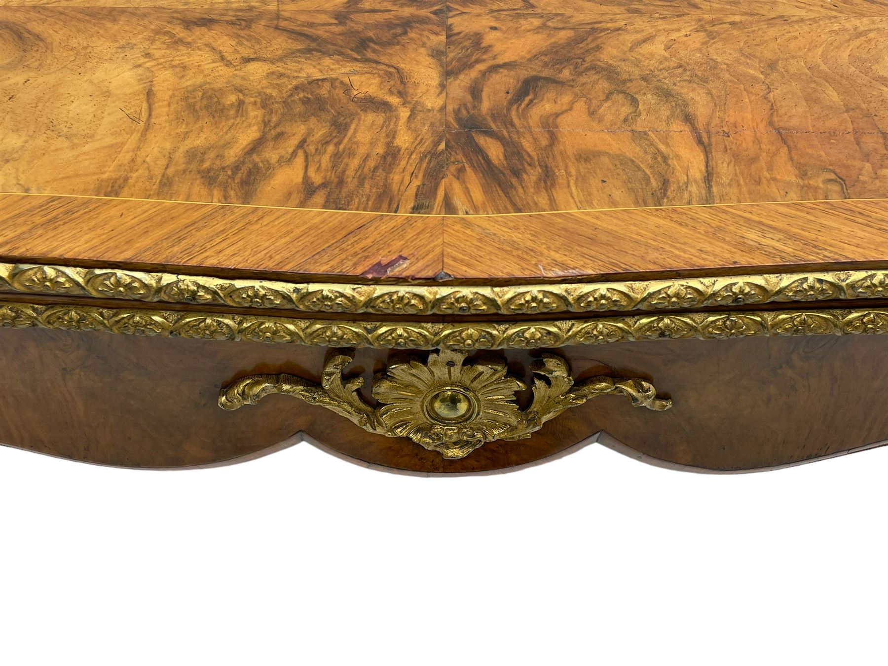 20th century French walnut and Kingwood card table, shaped fold-over top with figured quarter-matched veneers and floral egg and dart moulded edge in gilt metal, shaped aprons decorated with shell motifs with extending foliage, pull-out action base revealing storage well, on cabriole supports with ornate gilt metal mounts 