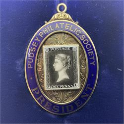Silver and enamel oval locket pendant, inscribed Pudsey Philatelic Society President, and decorated in enamel with a Penny Black stamp, opening to reveal a gilt interior, with presentation engraving verso, hallmarked Haseler & Restall, Birmingham 1981, contained within fitted case, H6.5cm