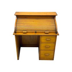 Leeway - late 19th century light oak child's roll-top desk, tambour top opening to reveal fitted interior with green felt writing surface and five pigeonholes, over three graduated drawers on the right side, raised on panelled side supports