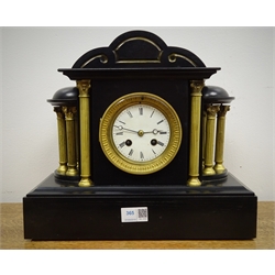  Victorian polished black slate mantel clock, temple shaped case with brass columns and white Roman dial, twin train movement striking the half hours on a bell, H31cm  