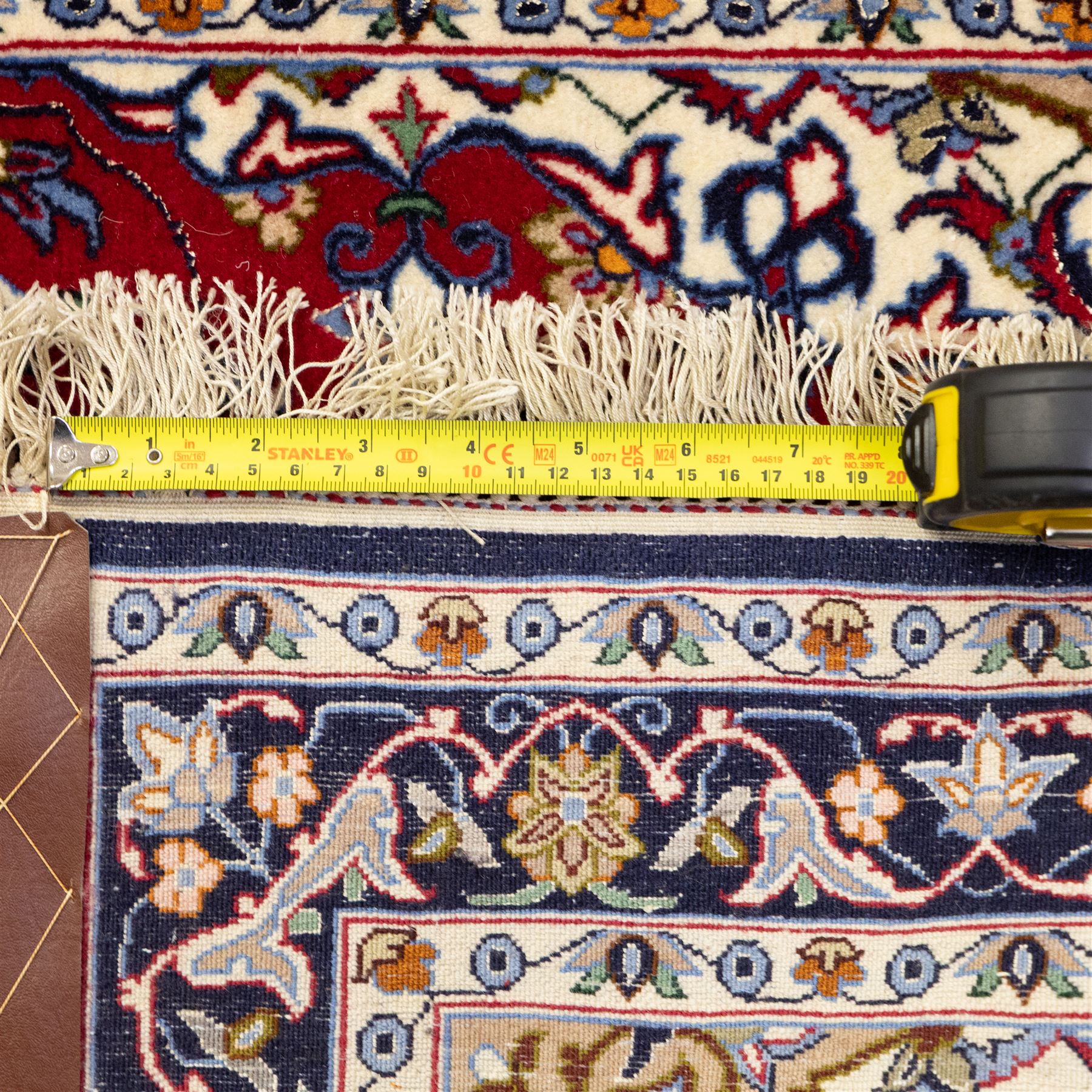 Two Central Persian rugs, ivory ground with a symmetrical foliate and floral design around a shaped cartouche medallion with a red floral and bird motif border with contrasting guard stripes, 142x76cm, Central Persian Kashan rug, crimson central field with a floral and foliate design with a stylized rosette medallion incorporating palmettes and scrolling vine work, enclosed by a dark navy border and multiple guard stripes, 117x68cm, (2)