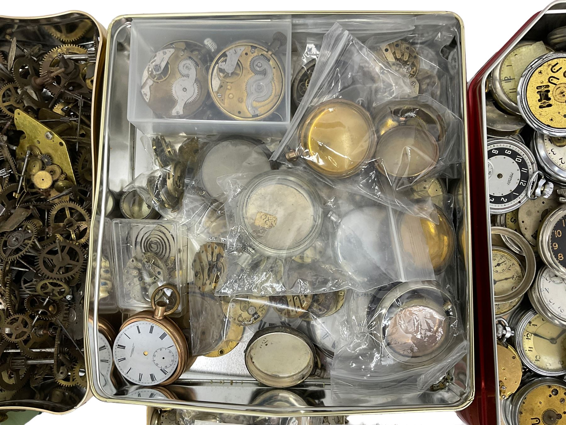 Large selection of dismantled clock wheels and pinions, watch movements