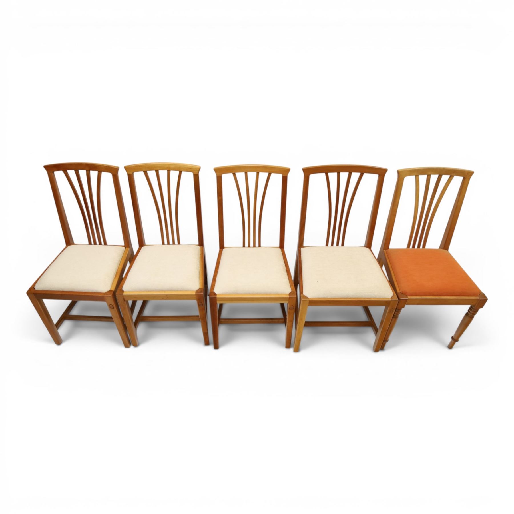 Knightman - set of nine cherrywood dining chairs, with fan splat backs and upholstered seats, raised on square legs joined by stretchers, comprising chairs of slight differing widths and one chair with turned front legs and orange upholstery and no Knight carving, the rest with recessed carved knight trademark, by Horace Knight of Old Mill Furniture, Balk near Thirsk 