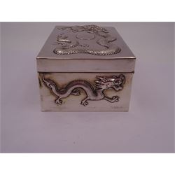 Late 19th century/early 20th century Chinese export silver mounted cigarette box, of rectangular form, decorated in relief with dragons, the hinged cover with similar dragon decoration and central blank oval cartouche, opening to reveal a softwood lined compartmentalised interior, stamped beneath with character mark and KMS for maker Kwong Man Shing, H6.3cm, W15.5cm, D9.5cm