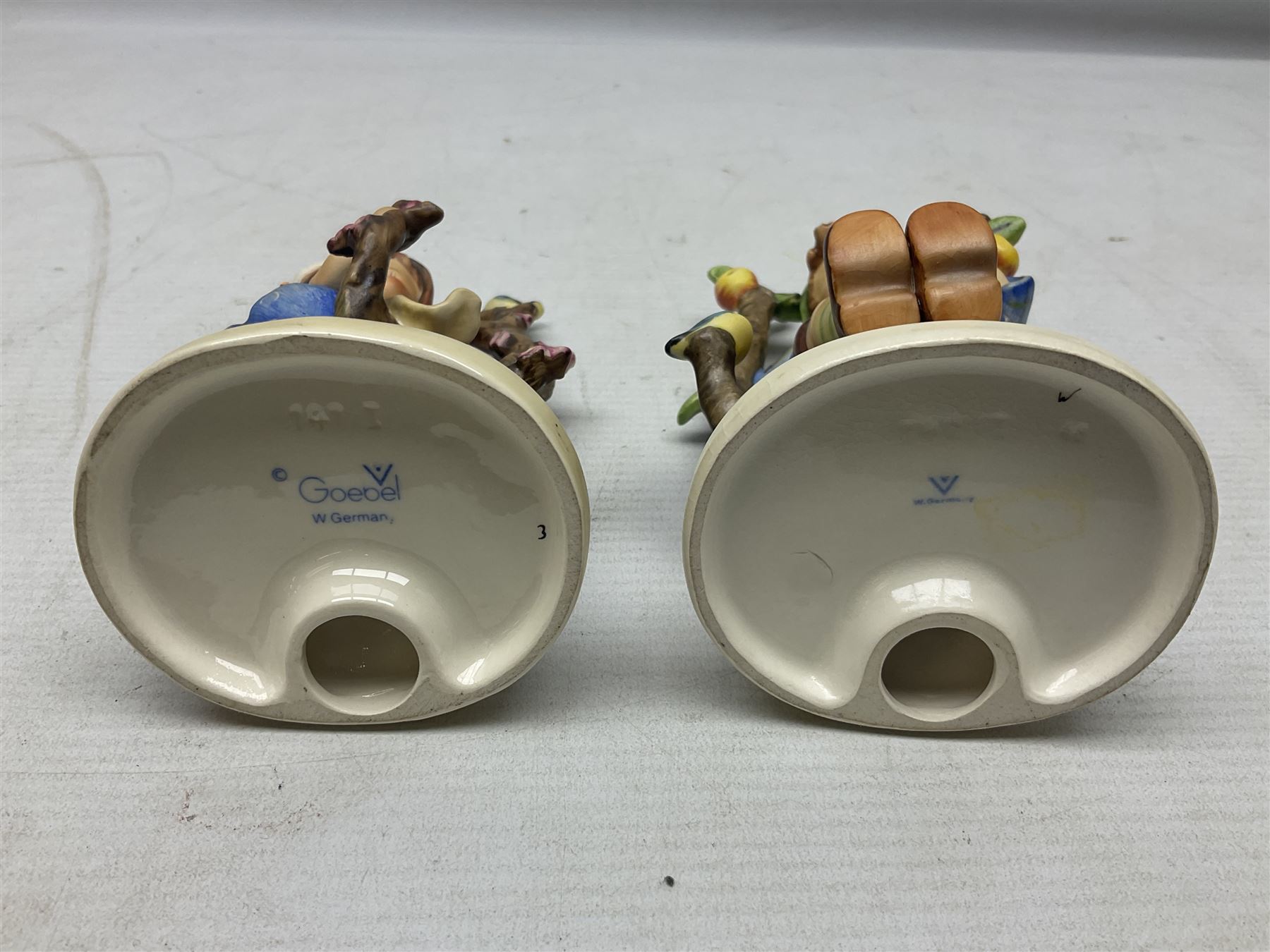 Seven Goebel Hummel figures, comprising Chimney Sweep 12/I, Apple Tree Girl 14/I, Apple Tree Boy,  Little Goat Herder 200/I, Surprise 94 3/0, Signs of Spring 203/20 and Wayside Harmony 111/30, tallest H15cm