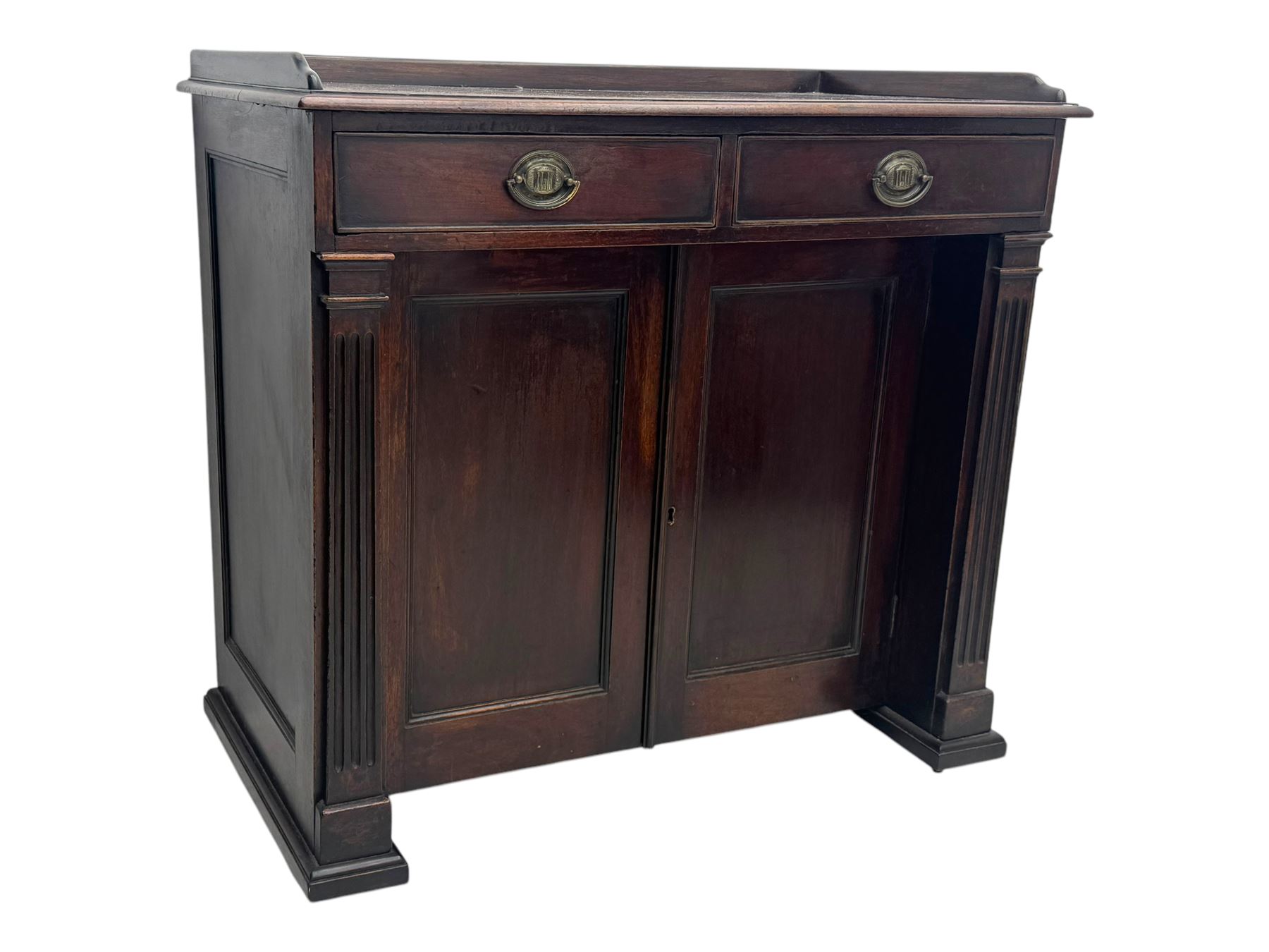 George III mahogany chiffonier or side cabinet, rectangular top with raised gallery and two frieze drawers, over double cupboard enclosing shelves, fluted side supports, raised on castors