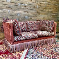 Knole type drop arm sofa with cushions in a traditional patterned upholstery,