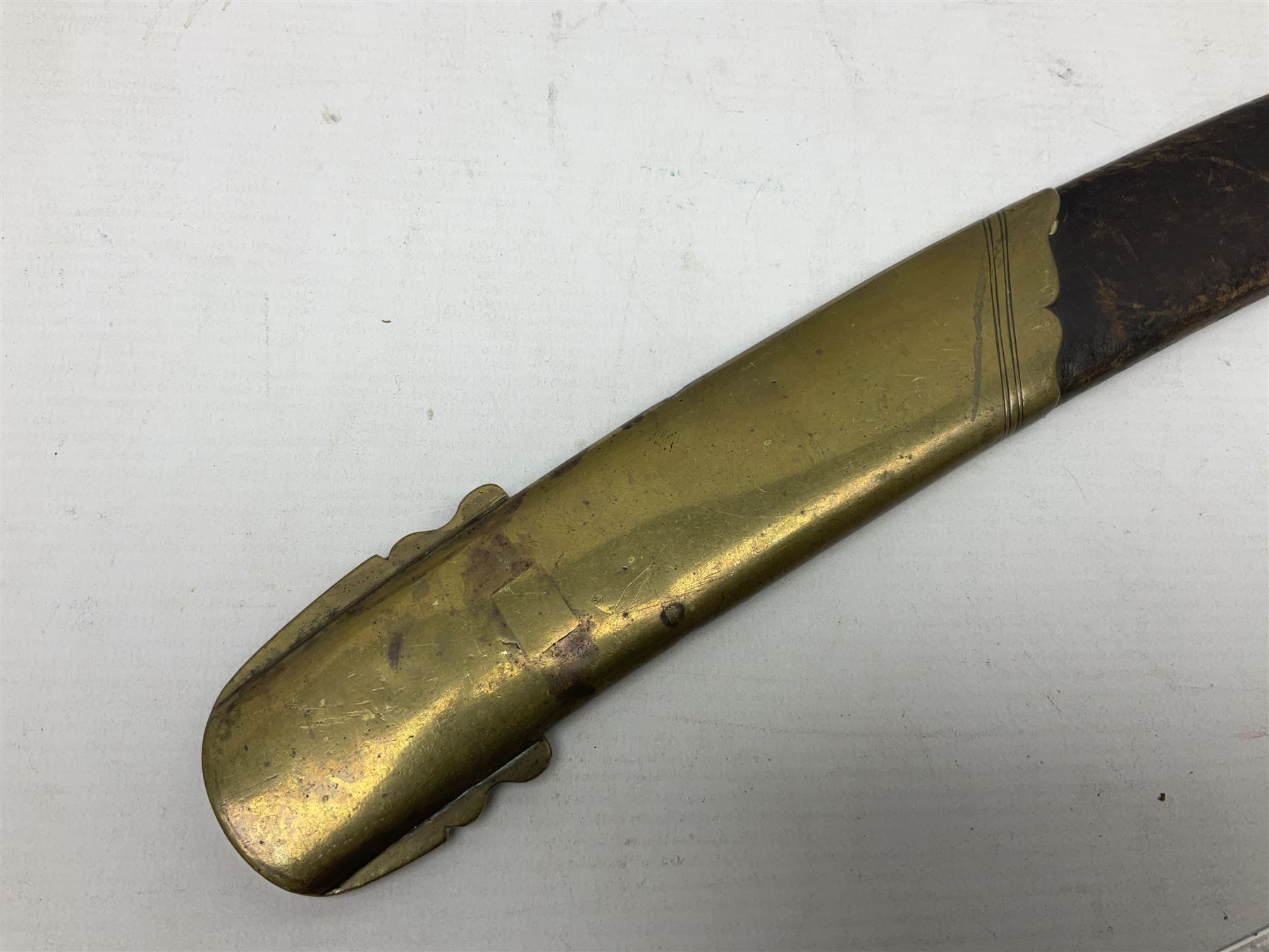 British pattern 1796 Light Cavalry Officer's sword, the 83.5cm curving steel blade marked 'W. Parker London' and 'Warranted' verso, brass stirrup hilt with half-round langets, knucklebow and backstrap with ribbed ivory grip; in brass mounted leather covered scabbard with two suspension rings L97cm overall. This item has been registered for sale under Section 10 of the APHA Ivory Act 