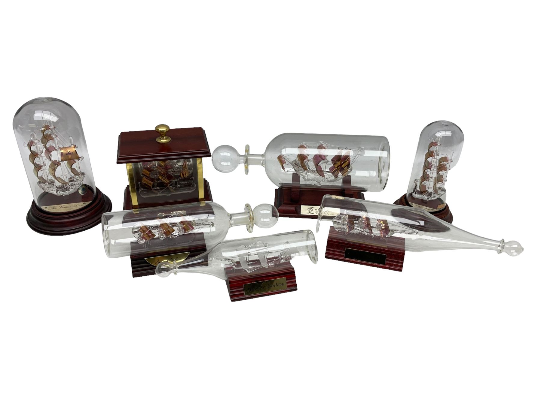 Collection of glass ships in bottles, with various stands and cases