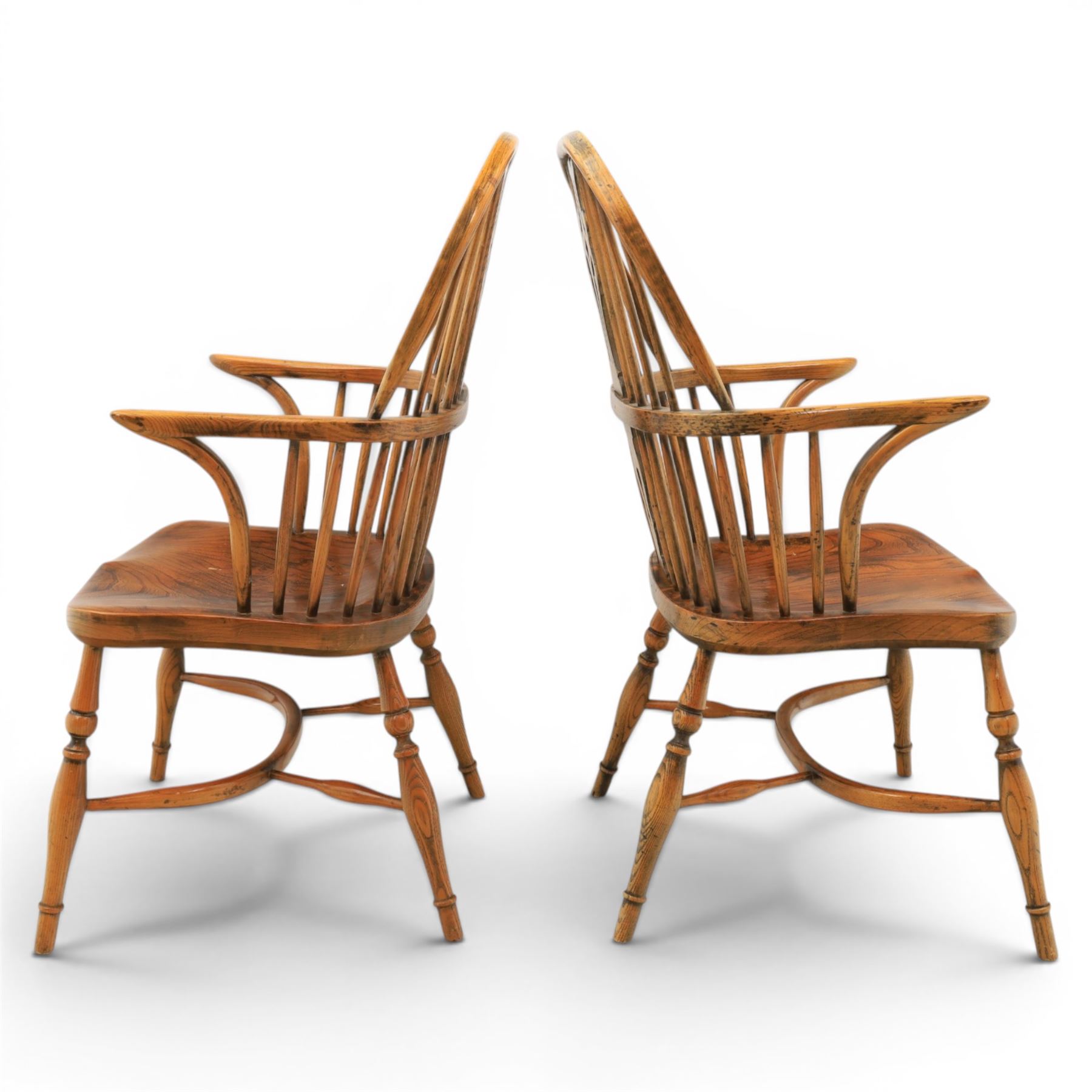 Pair of high back Windsor armchairs, fleur de lis back splat, dished seat, caroline stretcher