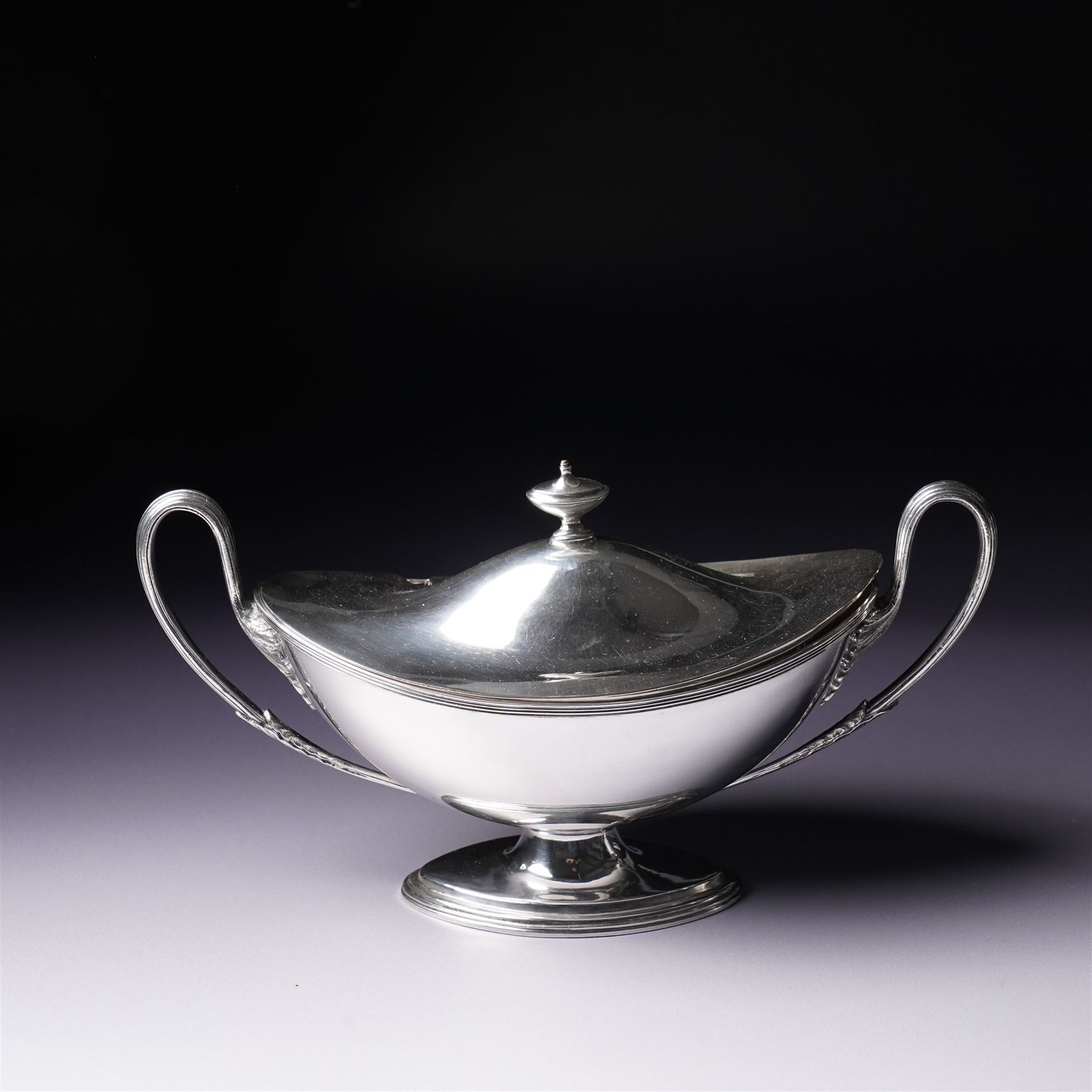 Pair of silver plated sauce tureens and covers of oval form with reeded loop handles L25cm overall