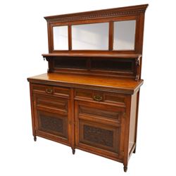 Late Victorian mahogany mirrored back sideboard, the mirror back with three bevelled mirror plates above a single shelf, rectangular moulded top over two frieze drawers with brass handles, above a twin panelled cupboard, carved recessed panels decorated with flowers and foliage, fluted uprights, raised on turned feet
