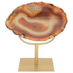 Pair of red agate slices, polished with rough edges raised upon gilt metal stands, H20cm