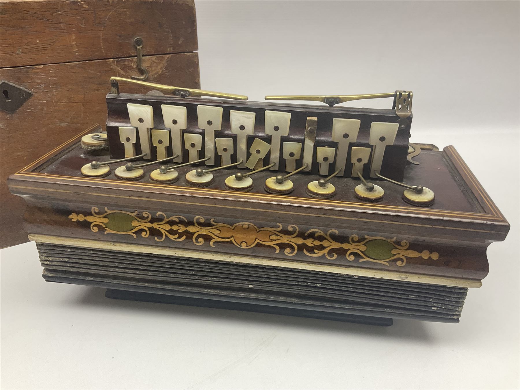 19th Century inlaid rosewood Flutina accordion, stamped Busson of Paris, having sixteen mother of pearl keys and six fold floral decorated bellows L30cm; in baize lined mahogany box