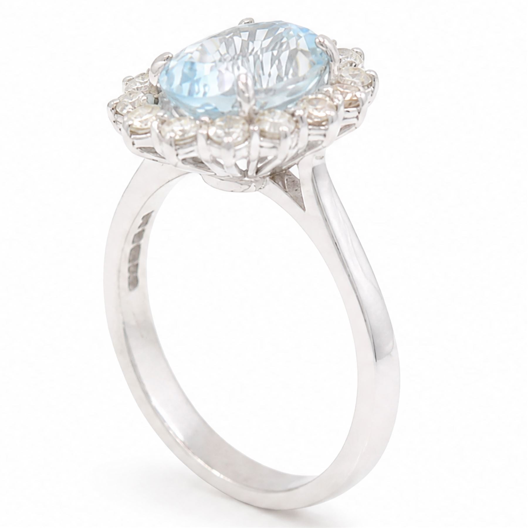 18ct white gold aquamarine and diamond cluster ring, single oval cut aquamarine of approx 2.80 carat, surrounded by fourteen round brilliant cut diamonds, hallmarked, total diamond weight approx 0.60 carat