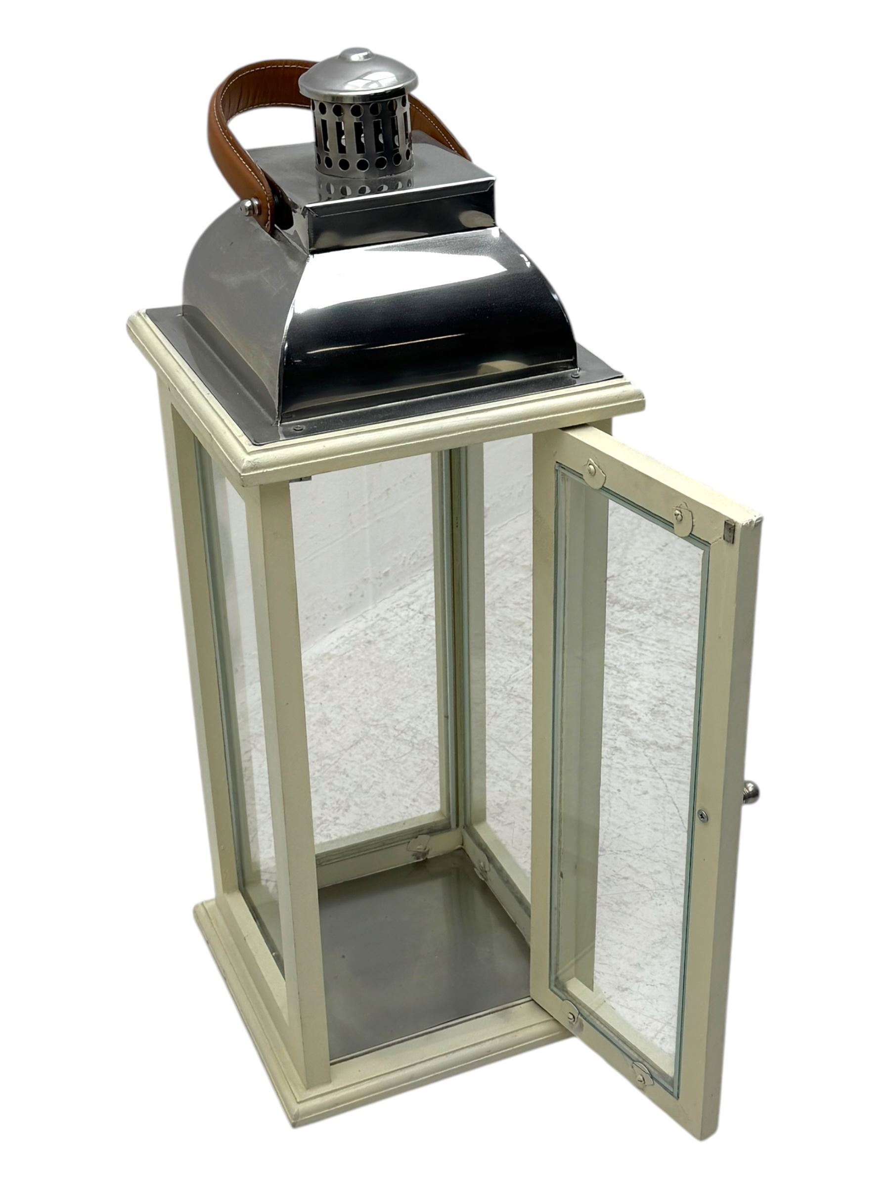 Contemporary painted wooden wine cabinet, rectangular form with carved leaf moulded cornice over single drawer and fifteen bottle compartments, flanked by spiral twist pilasters; together with a cream painted and chrome lantern, with glazed sides and leather handle (2)