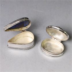 Two modern silver pill boxes, the first example of oval form, the hinged cover set with a tigers eye cabochon with beaded mount, and engraved scroll edge, hallmarked NC, London import 1995, W3cm, the second of teardrop form, the hinged cover set with lapis lazuli, marked 925, L3.5cm