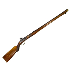  Late 18th/early 19th century continental flintlock hunting rifle the walnut stock with brass butt, chequered fore-end carved with a lion mask, brass trigger guard, chased lock plate, 95cm octagonal barrel inscribed Johann Novak un Klattau and brass mounted under-barrel ramrod 135cm overall  