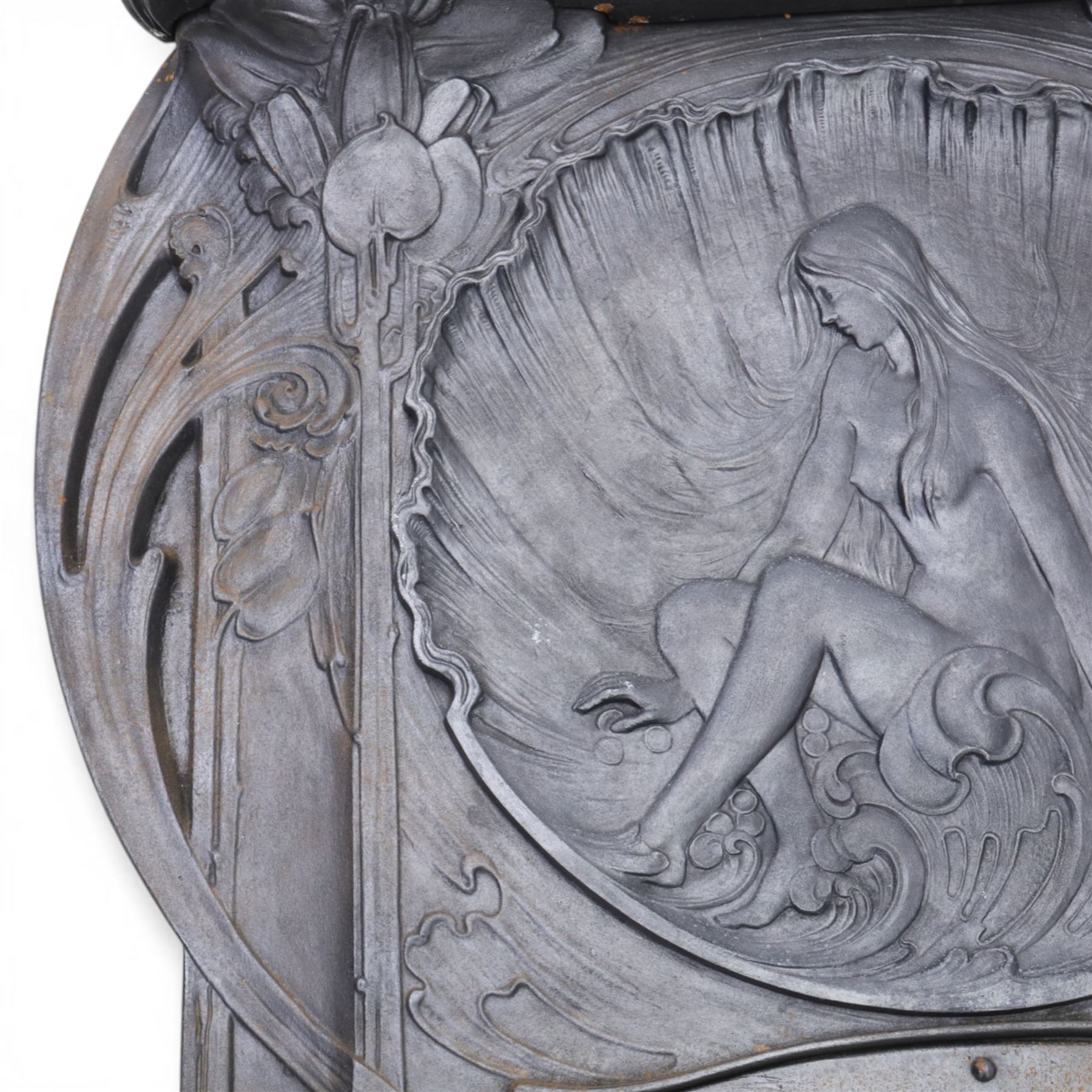 Art Nouveau cast iron fireplace, shaped hood with scrolling foliate crest, relief cast panel of female figure seated within shell form amidst wave motifs, uprights cast with foliate designs