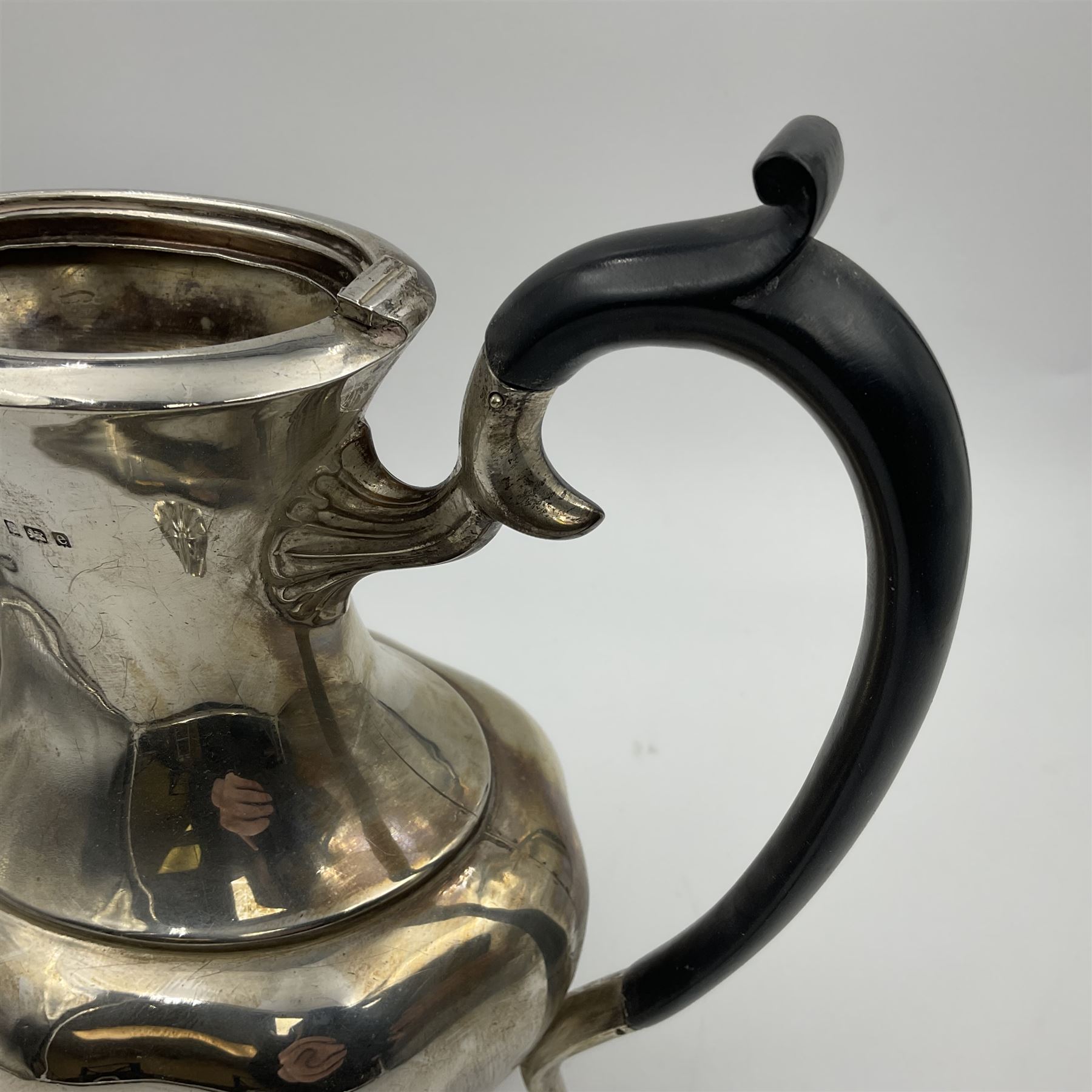 Five piece Edwardian silver tea service, comprising teapot and coffee pot, each with ebonised scroll handle, tea caddy with hinged cover, twin handled open sucrier, and milk jug, each of rounded bombe form, upon four paw feet, hallmarked William Adams Ltd, Birmingham 1904 and 1905, coffee pot H26cm
