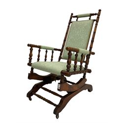 Early 20th century walnut framed American rocking chair, upholstered seat, back and arms