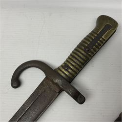 WWI Remington Pattern 1913 bayonet, the 43cm fullered blade with various marks to the ricasso including date code 11 16; in leather covered scabbard with various stamps including JWB 17 L58cm overall; and a French Model 1866 sabre bayonet (no scabbard)