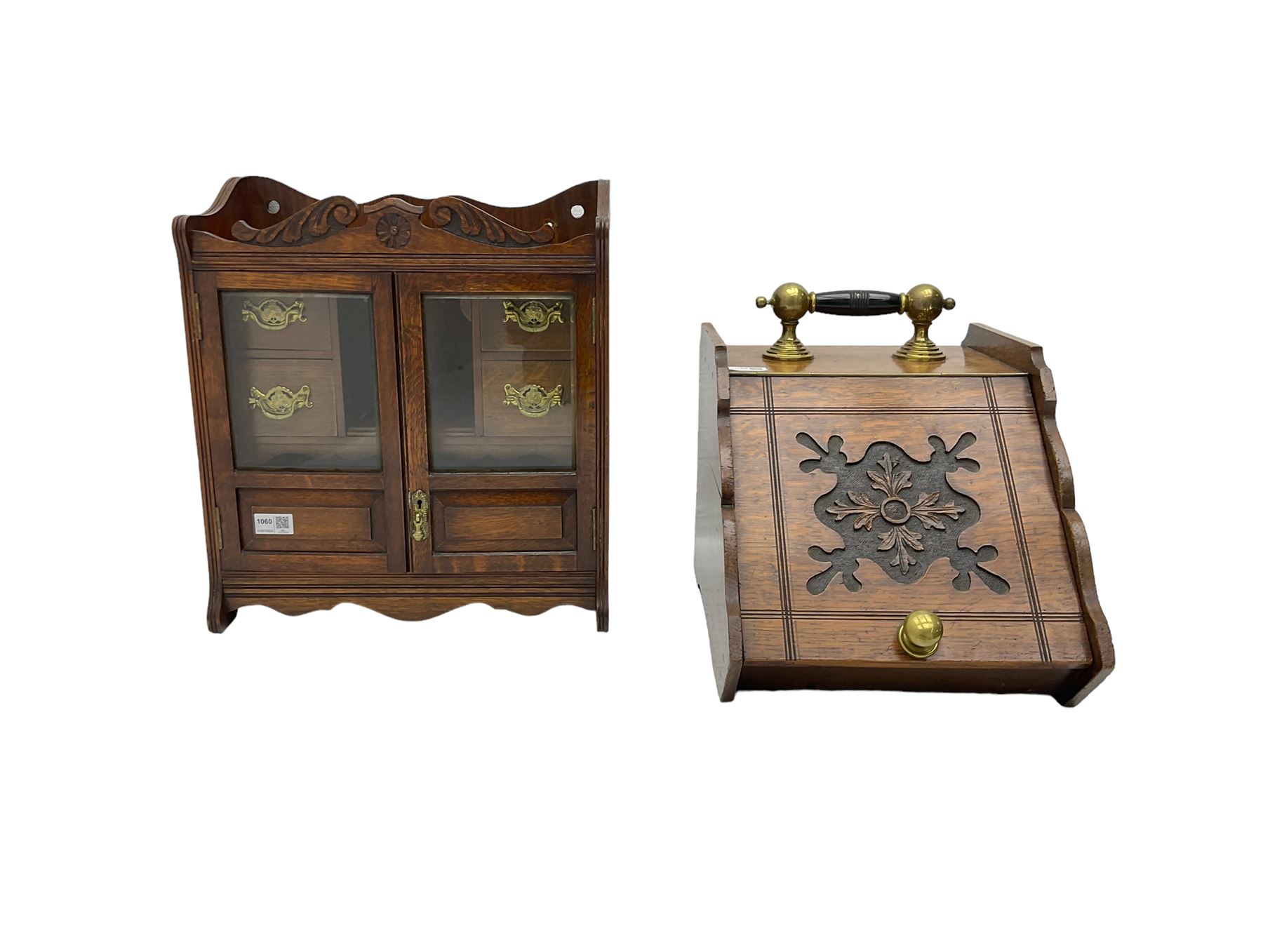 Edwardian oak smokers cabinet, broken swans neck pediment, two bevelled glazed and panelled doors enclosing four small drawers and pigeon hole (W42cm H45cm); Edwardian oak coal scuttle, carved fall-front with brass handles (W32cm H37cm)